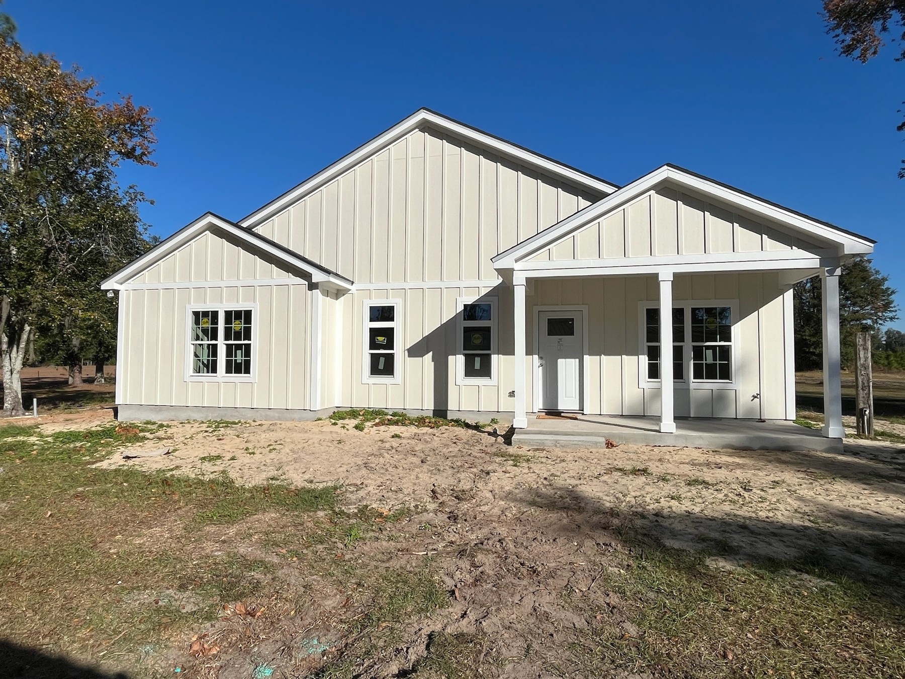 Completed white farmhouse with a covered front porch